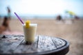 Glass of pinacolada on the table on the beach Royalty Free Stock Photo