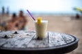 Glass of pinacolada on the table on the beach Royalty Free Stock Photo