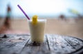 Glass of pinacolada on the table on the beach Royalty Free Stock Photo