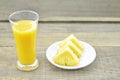 Glass of pineapple juice, fresh pineapple cut slices on wooden table Royalty Free Stock Photo