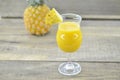 Glass of pineapple juice, fresh pineapple and slices on wooden background Royalty Free Stock Photo