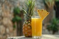 Glass of pineapple juice with a slice and whole pineapple Royalty Free Stock Photo