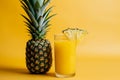 Glass of pineapple juice with a slice and whole pineapple Royalty Free Stock Photo