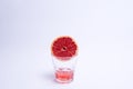 Glass of pink grapefruit juice over white background. Royalty Free Stock Photo