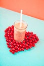 A glass of pink smoothies Berries of a sweet cherry on a blue background. Place for text Royalty Free Stock Photo