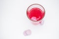 In a glass with pink water, a soluble, instant or dissolve pink tablet bubbles. Nearby are similar tablets: vitamin C, dietary Royalty Free Stock Photo