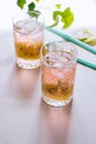 A glass of pink wine in a crystal glass on a marble background, green ivy