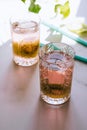 A glass of pink wine in a crystal glass on a marble background, green ivy