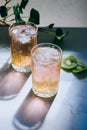 A glass of pink wine in a crystal glass on a marble background, green