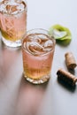 A glass of pink wine in a crystal glass on a marble background, green ivy