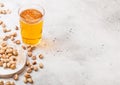 Glass pint of craft lager beer with pistachio nuts on stone kitchen table background. Beer and snack. Space for text Royalty Free Stock Photo