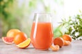 Glass pitcher with citrus juice and fruits on table Royalty Free Stock Photo