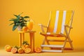 A glass pitcher filled with refreshing orange juice, garnished with fresh oranges, sits on a wooden table and a beach chair