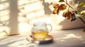 Glass pitcher of tea sits on a white plate on a table Royalty Free Stock Photo