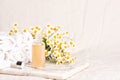 Glass and plastic bottles of essence or serum and with chamomile flowers Royalty Free Stock Photo