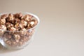 Glass plate. Caramel pop corn. Light background