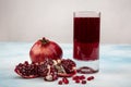 A glass of pomegranate juice with fresh pomegranate fruits on wooden table. Vitamins and minerals. Healthy drink concept Royalty Free Stock Photo