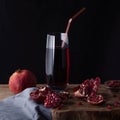 Glass of pomegranate juice with pomegranate slices and garnet fruit