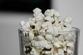 Glass with popcorn on blurred light background. Place with copy space for text. snack or treat for people in cimena Royalty Free Stock Photo