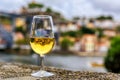 Glass of port wine with the blurred cityscape of Porto Portugal in the background Royalty Free Stock Photo