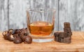 Glass of poured homemade whiskey with ingredients for cooking