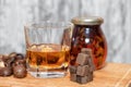 Glass of poured homemade whiskey with ingredients for cooking