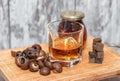 Glass of poured homemade whiskey with ingredients for cooking