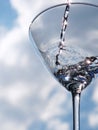 Glass of pouring water with reflection