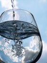 Glass of pouring water with reflection Royalty Free Stock Photo