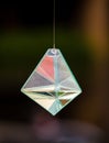 Glass prism refracting light in vivid rainbow colors