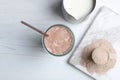 Glass with protein shake, jug of milk and powder on white wooden table Royalty Free Stock Photo