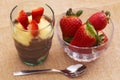 Glass with pudding and mini bowl strawberries