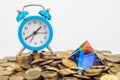 The glass pyramid and the table clock lie on a pile of ten-ruble Russian coins Royalty Free Stock Photo