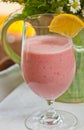 Glass of raspberry coconut smoothie with a slice of lemon Royalty Free Stock Photo