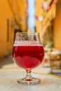 Glass of a raspberry Lambic ale at an outdoor restaurant in old town Nice France