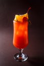 Glass of red alcohol cocktail with cherry, slice of orange and s Royalty Free Stock Photo