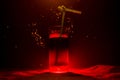 Glass of Red Alcoholic Cocktail on Dark Background with smoke and backlight. Fire hot coctail. Club concept Royalty Free Stock Photo