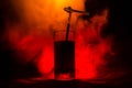 Glass of Red Alcoholic Cocktail on Dark Background with smoke and backlight. Fire hot coctail. Club concept Royalty Free Stock Photo