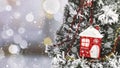 Glass red Christmas tree toy in the form of a house on a snowy Christmas tree. Royalty Free Stock Photo