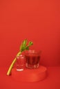 A glass of red cocktail with greens on the podium. Stylish alcohol tomato beverage Bloody Mary Royalty Free Stock Photo