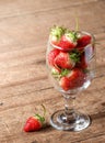 A glass of strawberries fruits with wood floor background Royalty Free Stock Photo