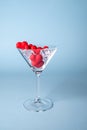 Glass with red heart shaped sugar candy and ice. Over blue background. Valentines Day, Royalty Free Stock Photo