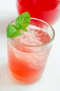 Glass of red juice (alcoholic cocktail, soft drink) with crushed ice and mint leaves Royalty Free Stock Photo