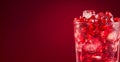 A glass of red pomegranate drink with ice cubes and red fruit pieces. pomegranate juice close up, with transparent ice, dark red Royalty Free Stock Photo