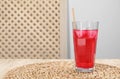 Glass of red soda water with ice cubes and straw on wooden table, space for text Royalty Free Stock Photo