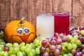 Glass of red and stum together with some green and red grapes and a pumpkin photographed in front of a Royalty Free Stock Photo