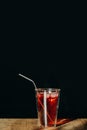 A glass of red sweet drink with metal straw or stainless straw  on wooden table Royalty Free Stock Photo