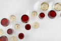 Glass of red and white wines on light background top view