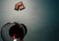 A glass of red wine with chocolate slices