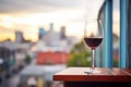 a glass of red wine on a balcony overlooking the city Royalty Free Stock Photo